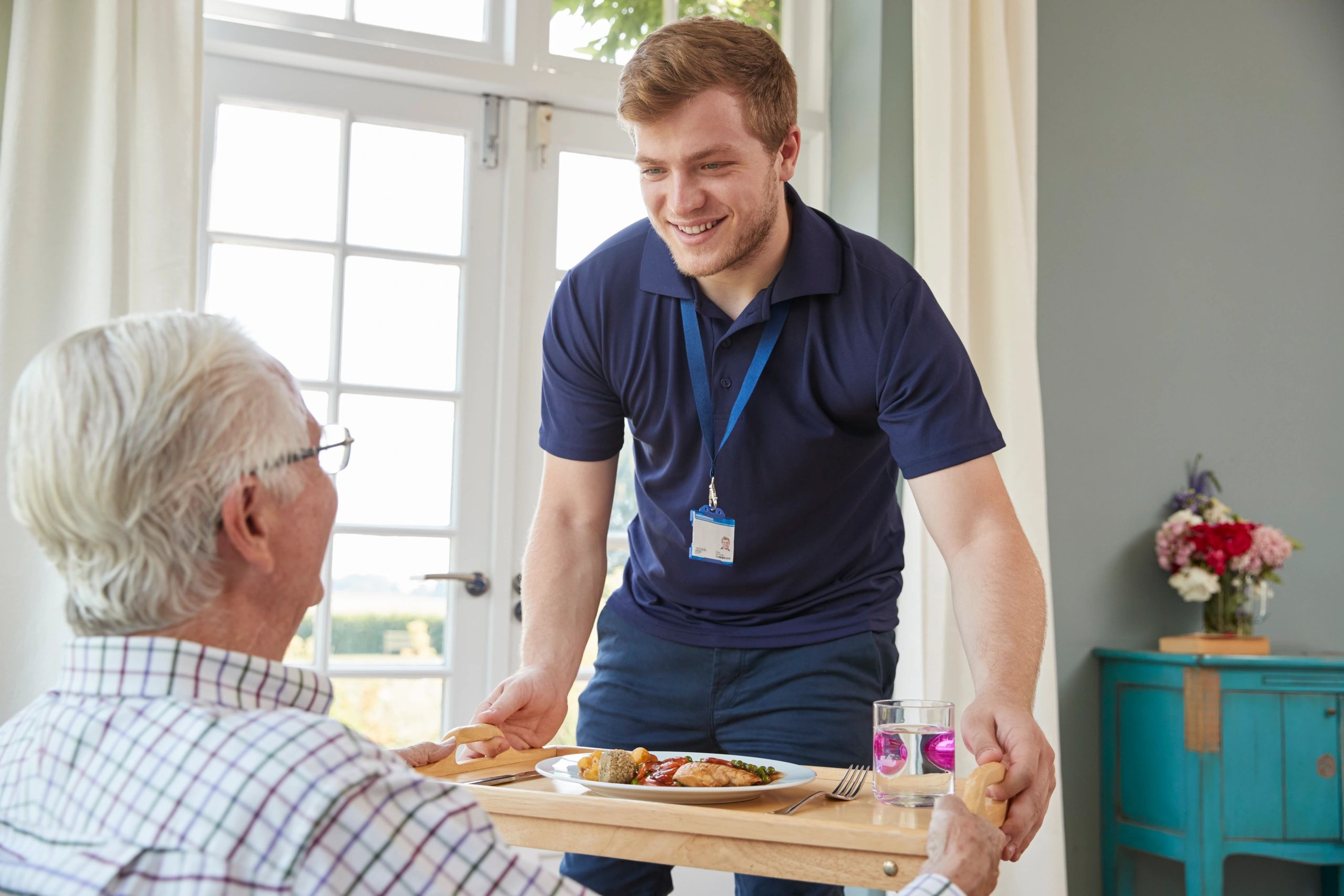 Caregiver and elderly woman smiling